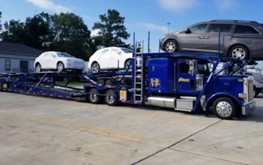 cars being loaded on a vehicle carrier