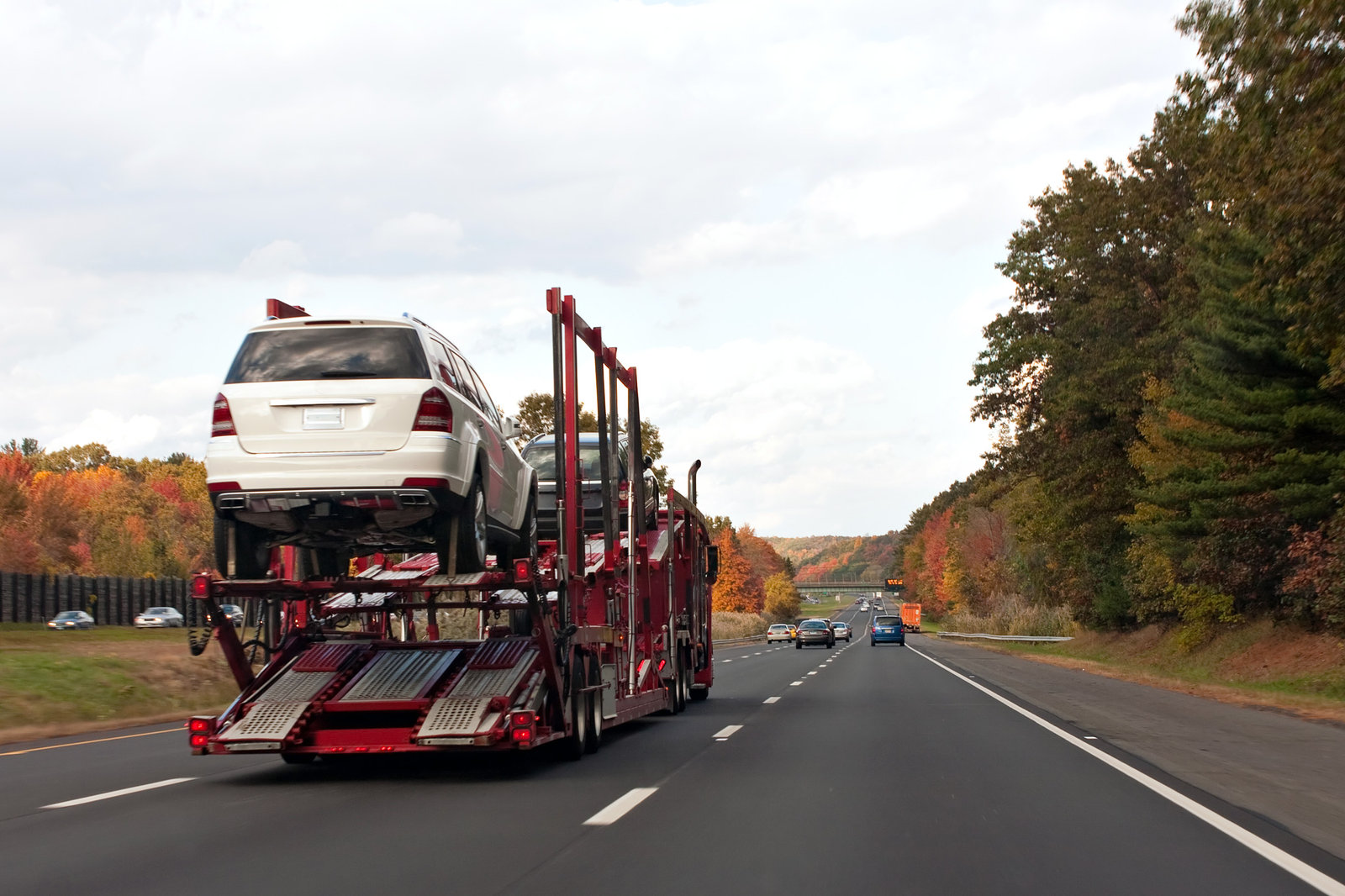 An open car carrier on the road.