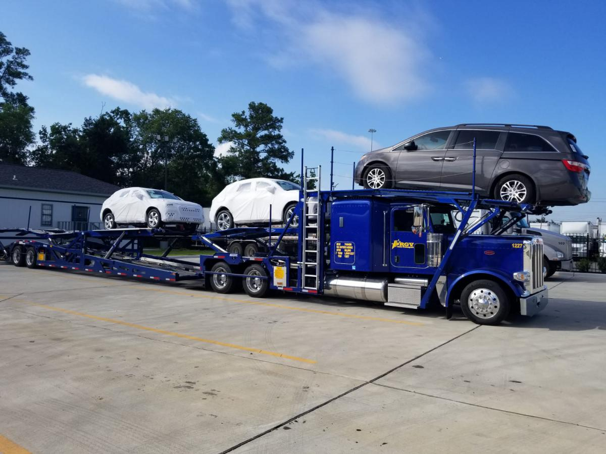 A couple of cars being transported across the country.
