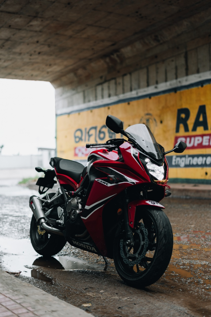 red motorcycle parked on a street