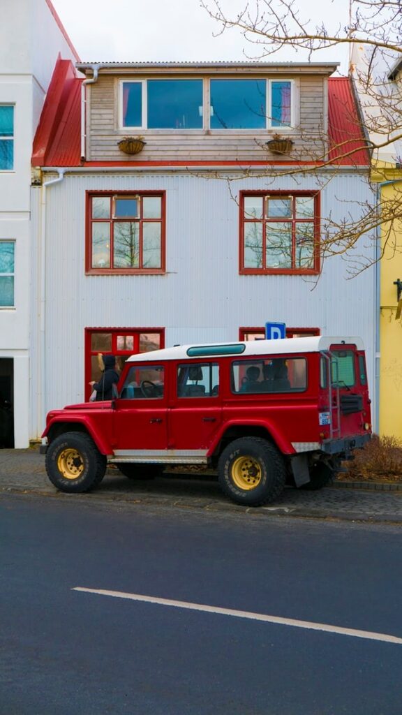 A red jeep parked in a driveway